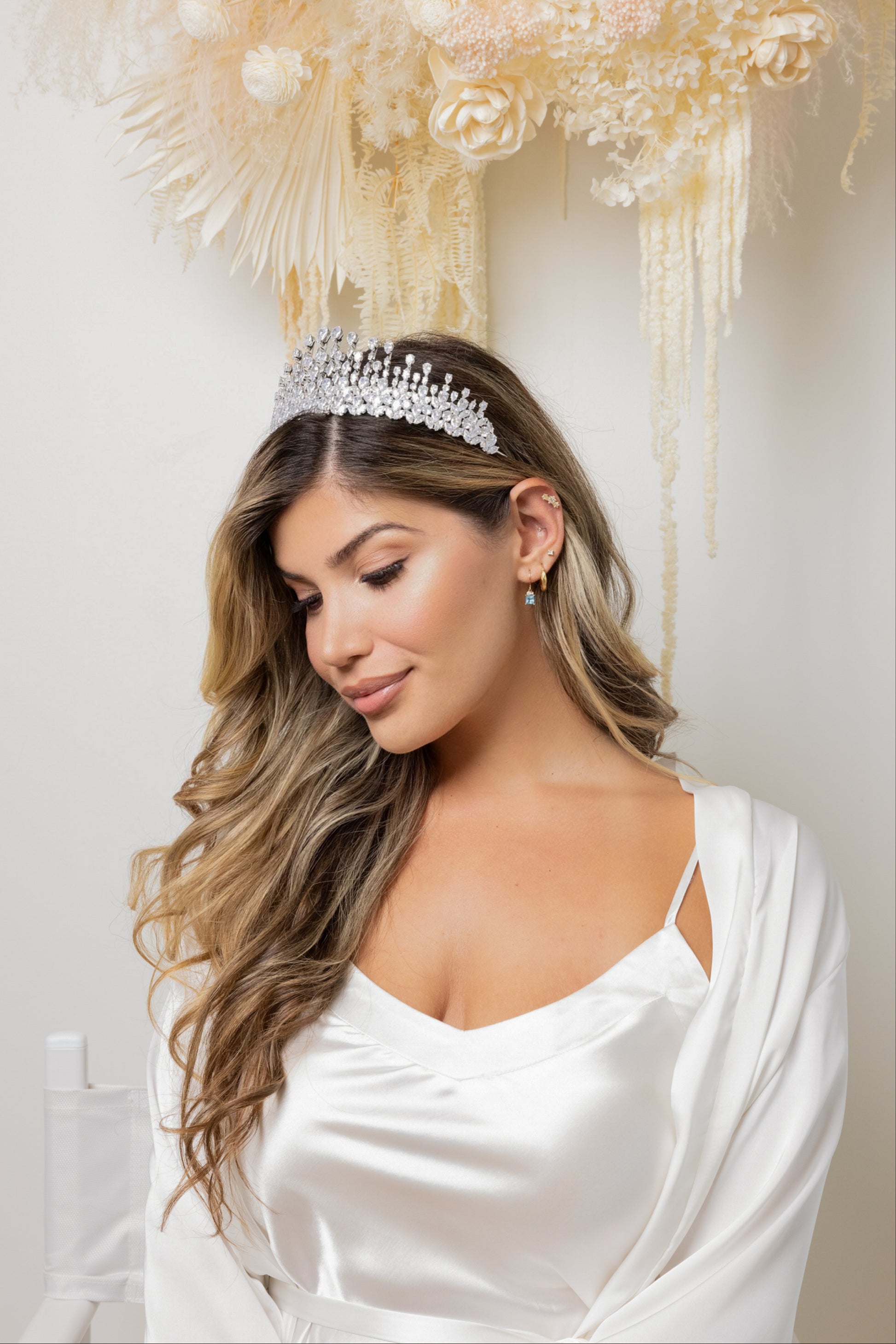 A stunning bride with a crystal Aubrey tiara on her head, looking elegant and radiant